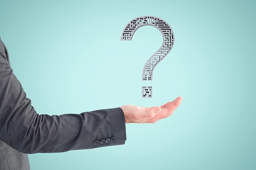 composite of hand holding questionmark graphic with blue background